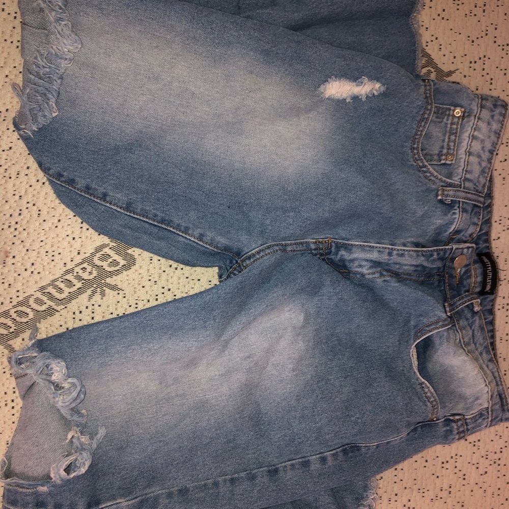 Pretty little thing mid wash extreme knee rip.